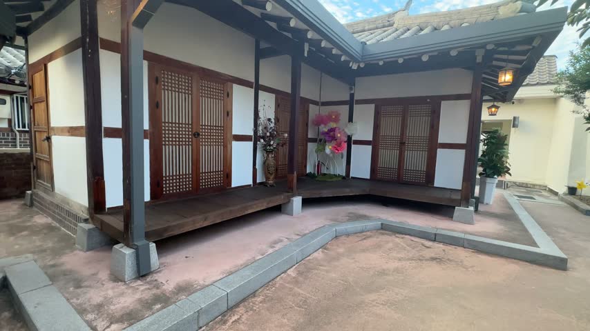 Tilt Shot of Traditional Korean House Courtyard in South Korea

Smooth tilt footage showing a traditional Korean-style house and peaceful courtyard with wooden doors, tiled roof details and surrounding greenery in South Korea.