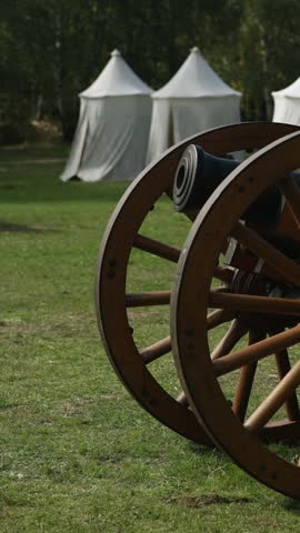 Vertical video. Old wooden cannon at medieval military camp
