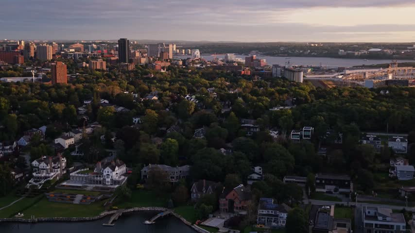 Explore the stunning aerial vistas of Halifax, Canada. This captivating view showcases the vibrant city and its natural surroundings, bathed in warm golden light.