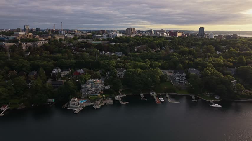 Experience stunning vistas of Halifax, Canada, featuring serene waterways, green parks, and charming architecture under a dynamic sky.