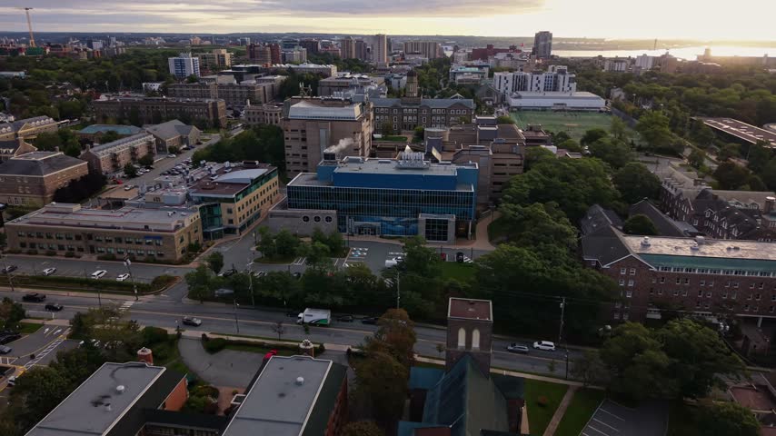 Experience stunning aerial views of Halifax, Canada, revealing a blend of modern buildings, green spaces, and the tranquil waterfront.