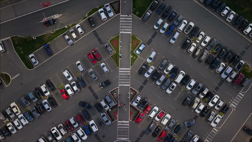 This shows a large parking area filled with various cars.