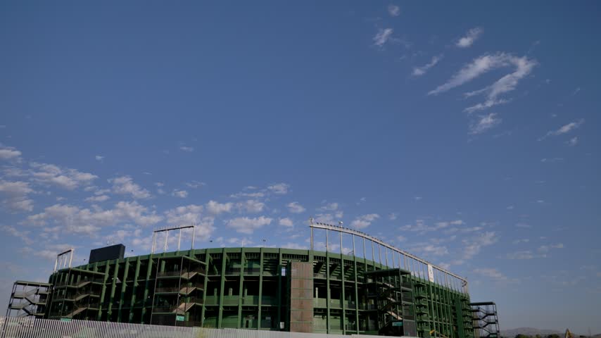 Tilt down camera shot revealing the exterior façade and structure of Manuel Martinez Valero football stadium in Elche, Spain. Outdoor sports venue, architecture, and professional soccer ground.