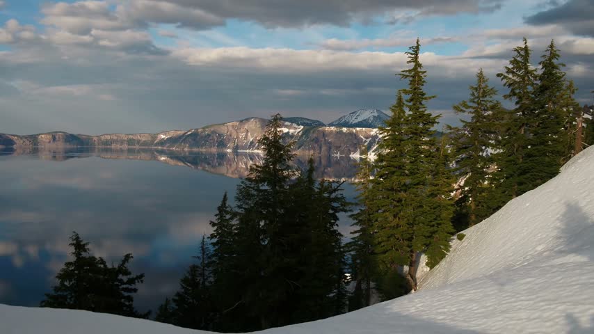 Panoramic View of Crater Lake National Park in Oregon with Snow Covered Mountains and Mirror