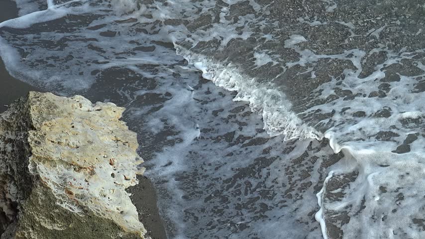 Video of the rocky shore of Crete Island with turquoise clear transparent Mediterranean sea water. Sandy beach near Gerapotamos. Crete, Greece.