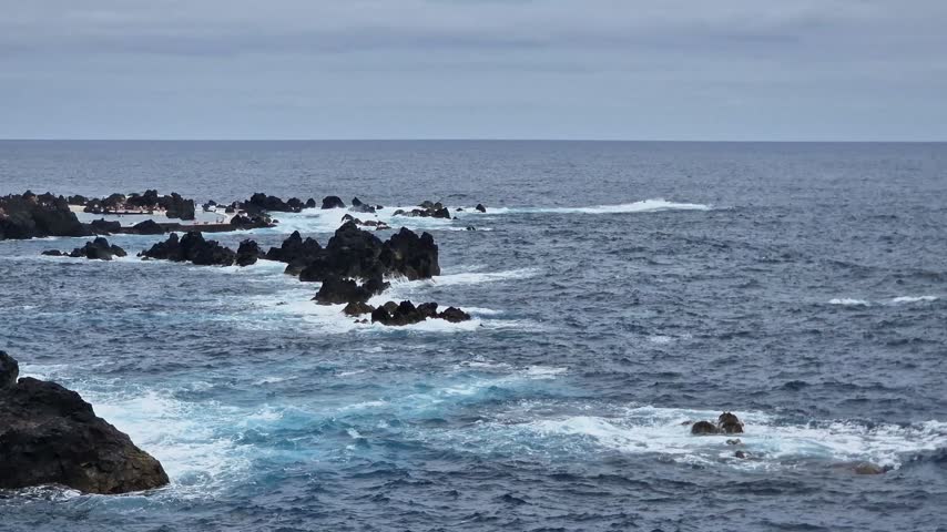 Crushing waves on the rocks at the natural swimming pools in Porto Moniz, Madeira Island.