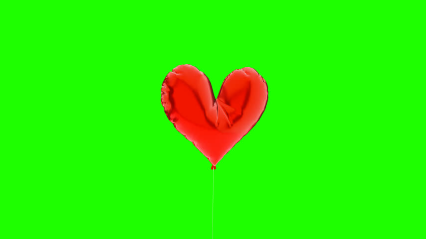 Red heart balloon isolated on green chroma key background for valentines day and love concept