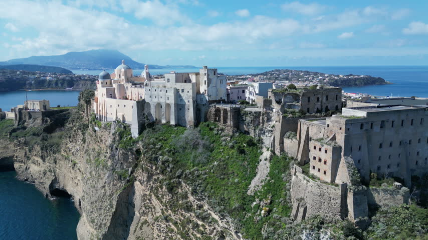 Aerial view of abbey (or church) of San Michele Arcangelo, located on sheer cliff on Procida, historic architecture and scenic landscape Italy Europe