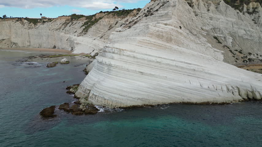 Flying past white rock formations of Scala dei Turchi, freely translated as 
