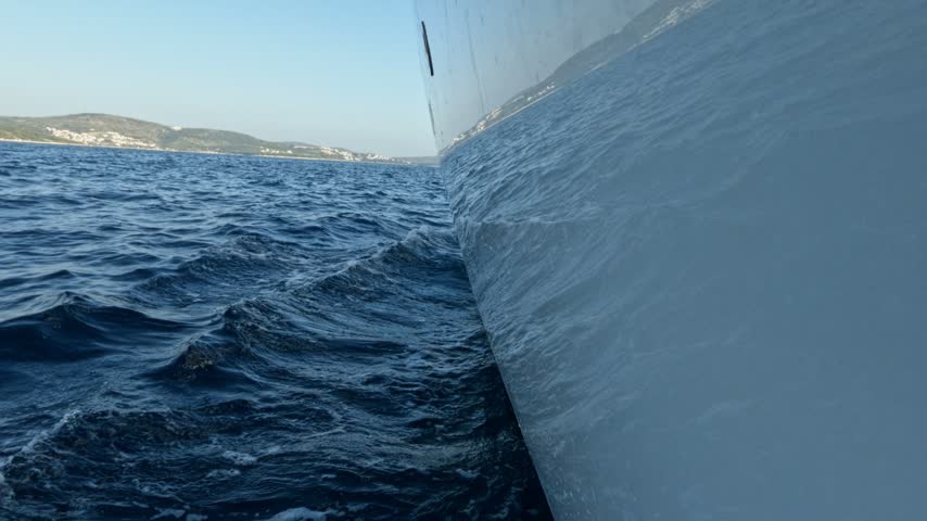 Side view from a boat sailing on the deep blue adriatic sea off the coast of croatia on a sunny day