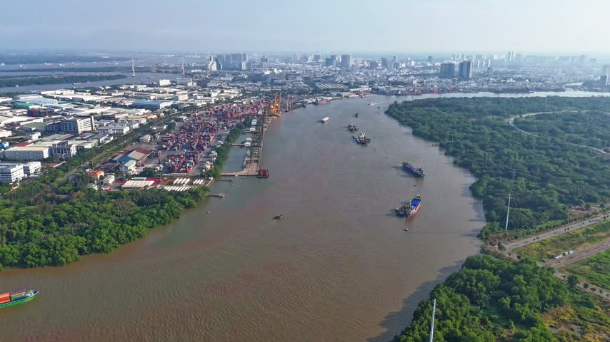 Aerial hyperlapse of Cat Lai port container terminal and cargo ship traffic, container yards, and river waterway logistics in Ho Chi Minh City, Vietnam