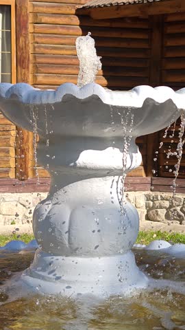 An old white fountain in the middle of the park.