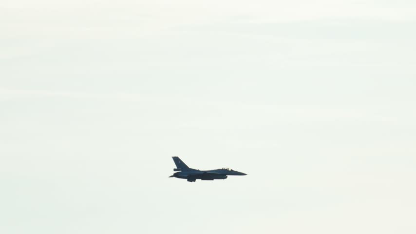 Supersonic F16 Fighting Falcon flying high in the sky. The tactical aircraft performs a spectacular turn, showing its combat capabilities