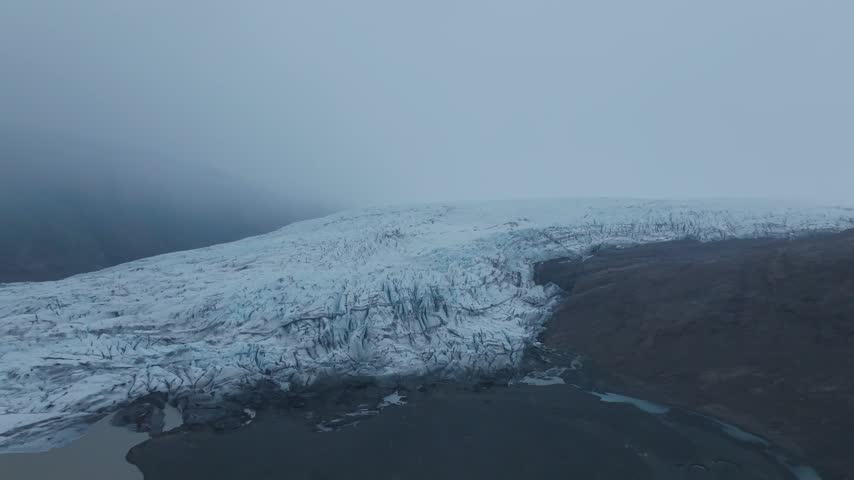 Glacier landscape with icy terrain and misty surroundings
