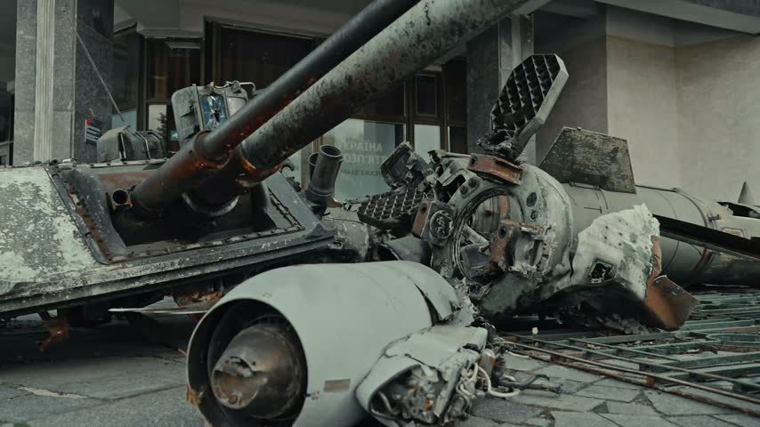 Destroyed military vehicles and missile wreckage in urban ruins
