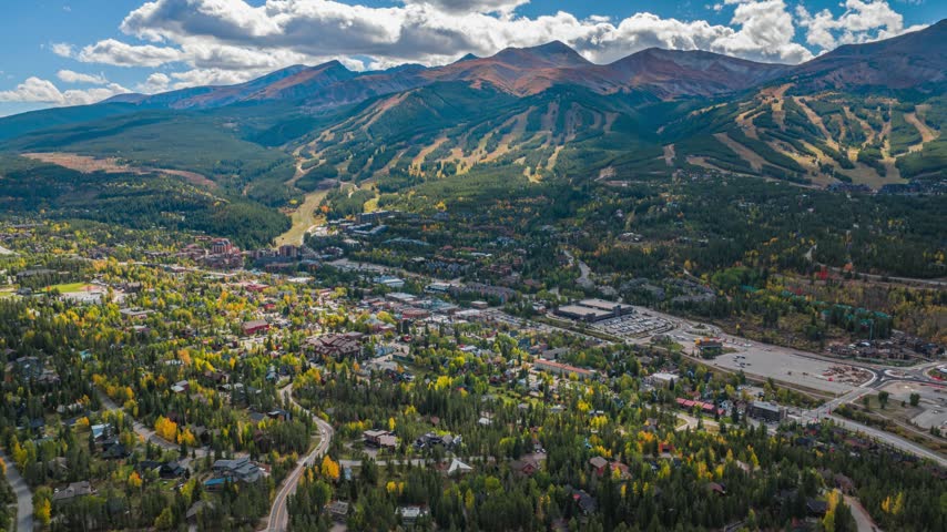 Aerial view of the town of Breckenridge nestled in the Rocky Mountains with autumn foliage, evergreen forests, and mountain peaks in Breckenridge, Colorado, United States.