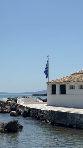 Holy Monastery of Panagia Vlacherna, white church on a small peninsula in turquoise sea, Kanoni, Corfu, Greece