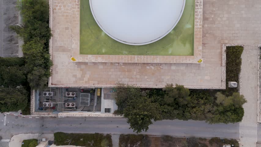 Aerial view of the white dome of The Israel Museum surrounded by stone architecture and lush trees in Jerusalem, Jerusalem District, Israel.