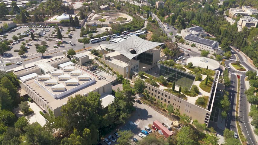 Aerial view of The Israel Museum in Jerusalem, featuring its unique architectural design, surrounding lush gardens, and adjacent parking facilities in Jerusalem, Jerusalem District, Israel.