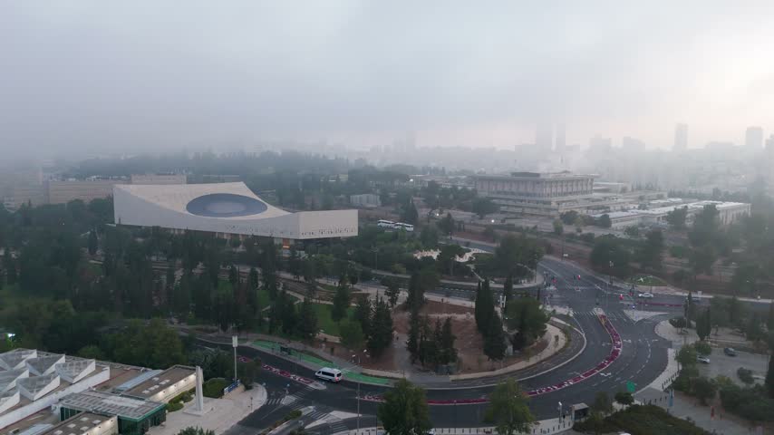 Aerial view of the modern National Library of Israel building surrounded by lush parkland and city roads in Jerusalem, Jerusalem District, Israel.