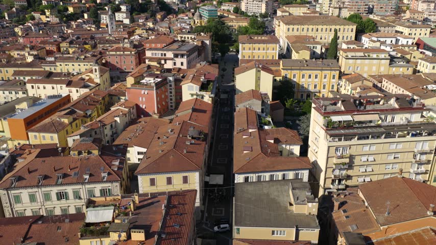 Aerial view of the city of Carrara with its dense urban architecture and terracotta rooftops in Carrara, Tuscany, Italy.