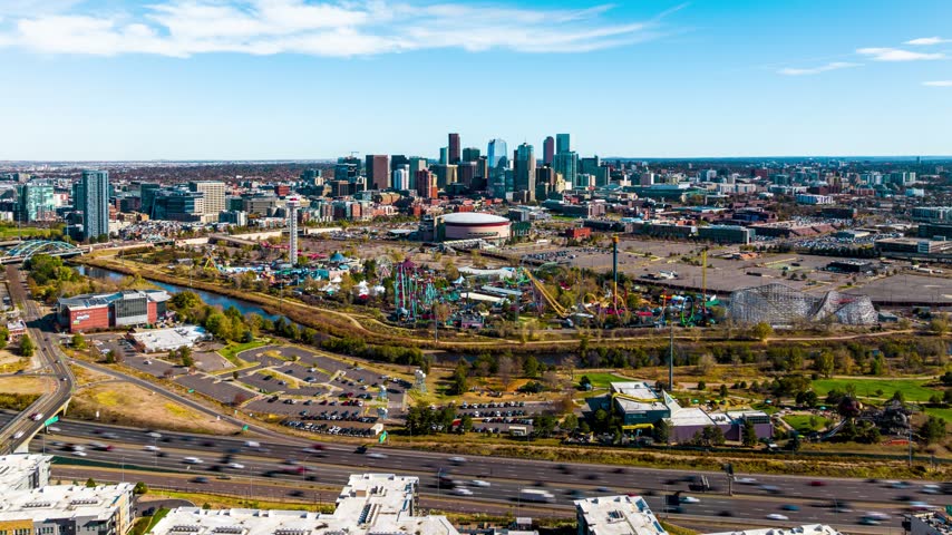 Aerial view of the Denver skyline featuring the amusement park, highway traffic, and urban landscape in Denver, Colorado, United States.