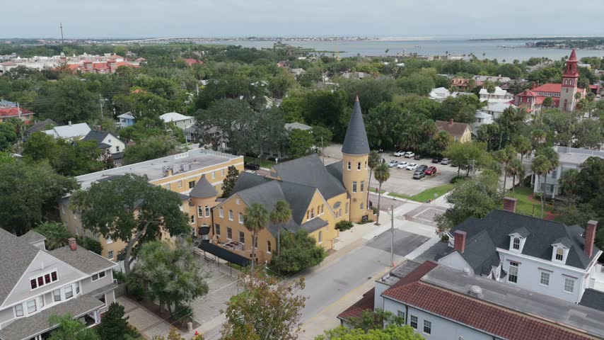 Aerial view of the historic Ancient City Baptist Church featuring its distinctive tower and surrounding urban landscape in St. Augustine, Florida, United States.