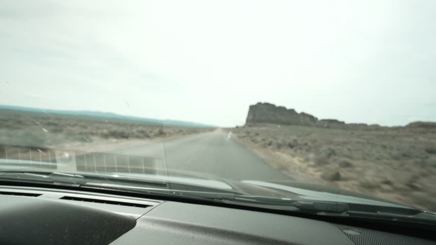 Driving POV toward Fort Rock on a desert road in Lake County Oregon