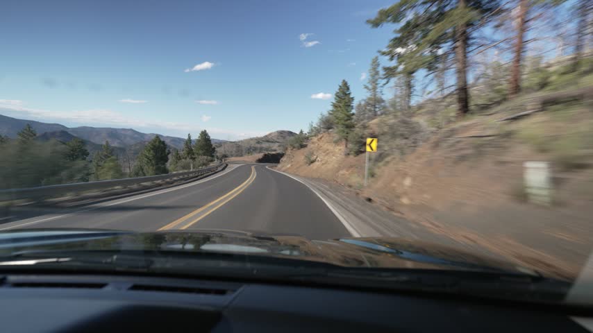 Driving POV on a curving highway in the Ochoco Mountains of Oregon