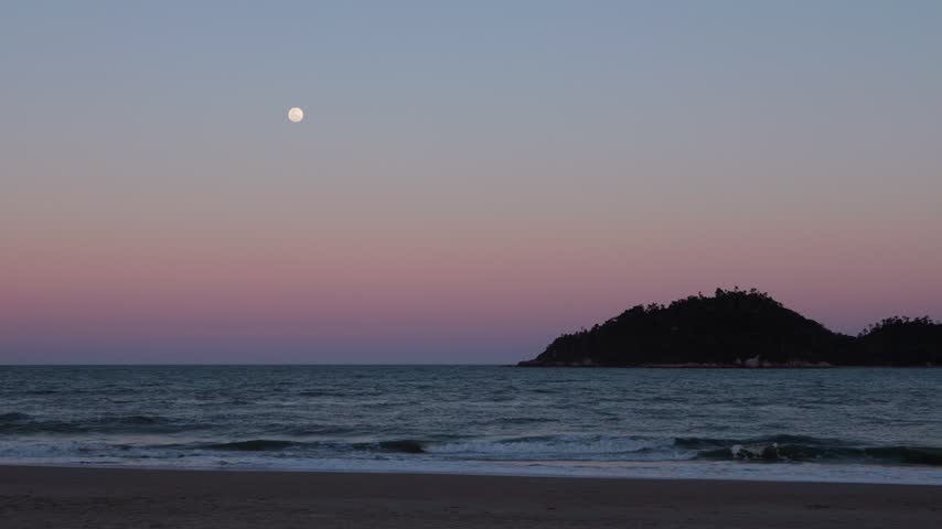 Full moon rising over a tropical beach with waves breaking under a magenta and blue sky
Beautiful night seascape with waves crashing on shore under a colorful gradient sky and full moon
Tropical beach at dusk with a full moon, breaking waves, and a vibrant magenta to blue sky