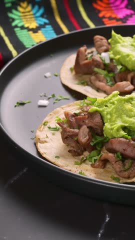 Authentic Mexican food tacos with onion, cilantro and guacamole