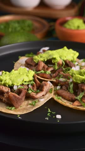 Traditional carne asada street tacos with onion, cilantro and guacamole