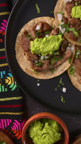 Top view of authentic Mexican beef street tacos with homemade guacamole