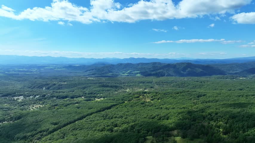 Drone aerial view of highland scenery. Nature, environment, view, blue sky, horizon, panorama, SDGs, ecology, forest, woodland.