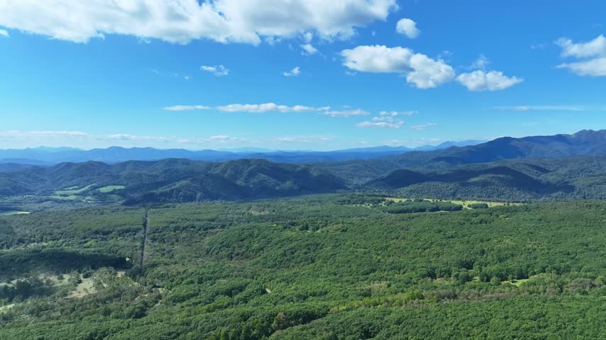 Drone aerial view of highland scenery. Nature, environment, view, blue sky, horizon, panorama, SDGs, ecology, forest, woodland.