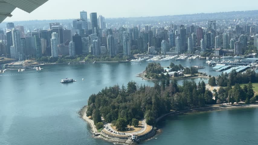 Seaplane view passes Stanley Park and downtown Vancouver
