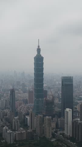 Taipei skyline tower standing amidst cityscape on foggy day
