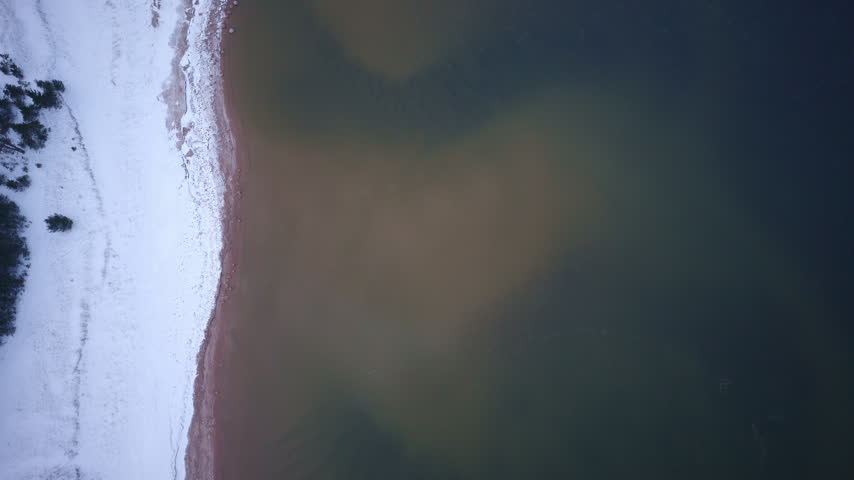 Aerial footage showing the snowy coast of Lake Superior in Northern Michigan