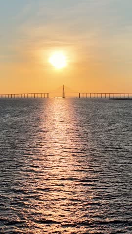 Amazonian Sunset At Manaus In Amazonas Brazil. Sunset Bridge. Boat Sailing. Amazon Black River. Amazonian Sunset In Manaus In Amazonas Brazil. Beautiful Sunset Skyline. Amazon Rainforest.