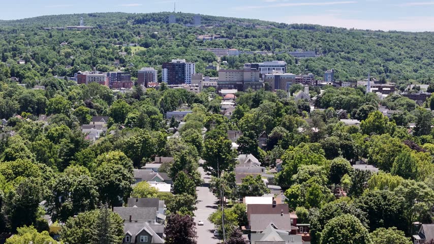 Rising drone shot of downtown ithaca in the summer.