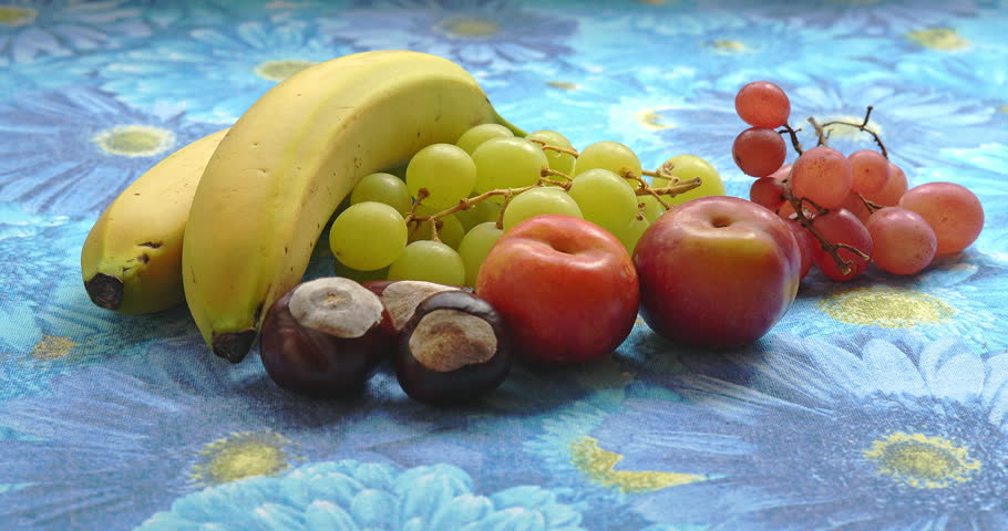 Still Life - Fruit composition with bananas, grapes, plums, and chestnuts