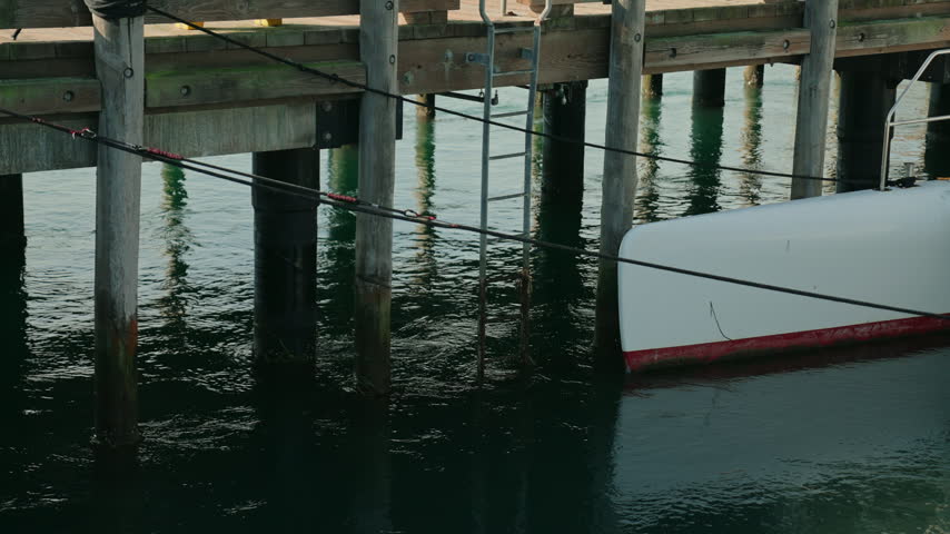 Sailing boat docking at the marina pier