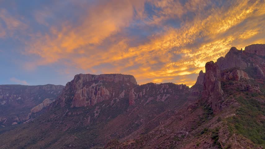 dramatic Golden Sunset Sky Over Chisos Mountains Rock Formations in Big Bend National Park Texas