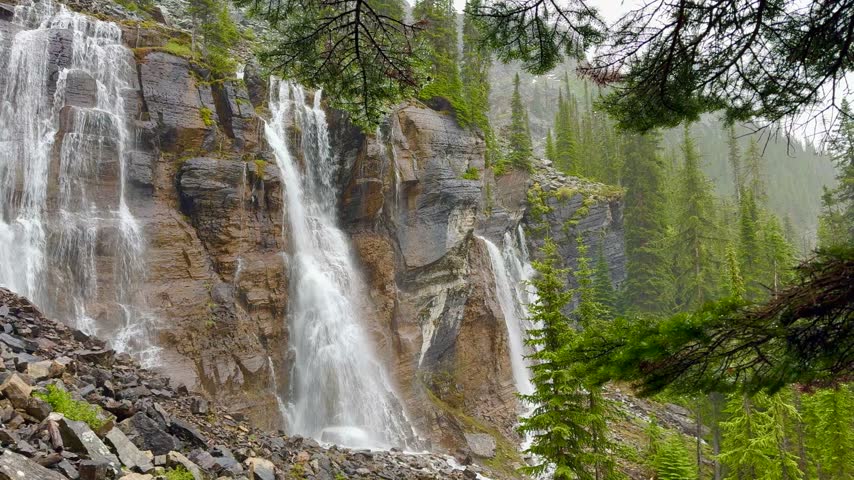 majestic Multi-Tiered Waterfall Cascading Down Rocky Mountain Cliff in Lake O