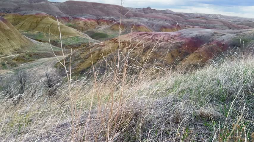 aerial Drone Rising Shot Over Colorful Banded Buttes of Badlands National Park in South Dakota