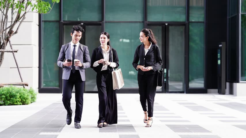 Corporate team arriving at work: a businessman and two businesswomen stride across a graphic paved plaza in front of a glass lobby, coffee in hand, clean architectural lines behind.