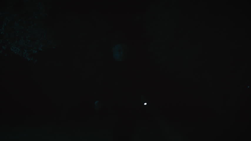 Spooky man outdoor with flashlight in the night 