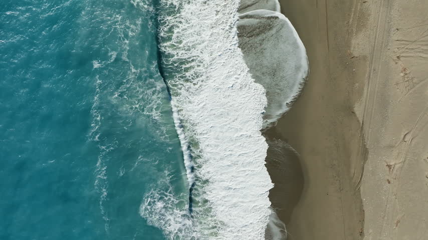 Sea waves moving and crashing near a hut 