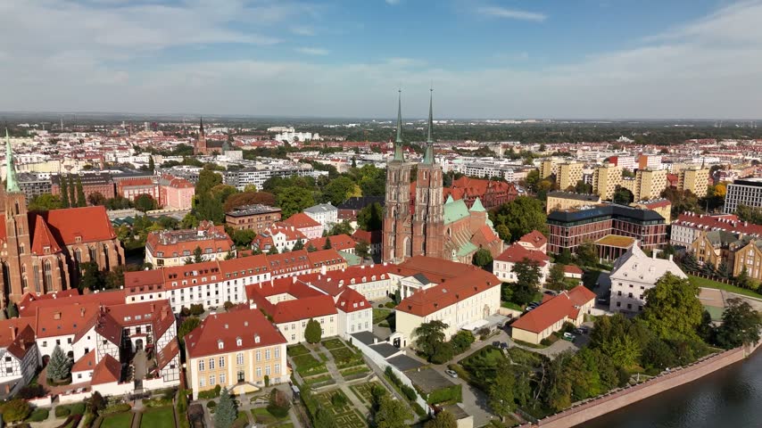 Wrocław Cathedral twin spires and Ostrów Tumski rooftops on a sunny day, Poland