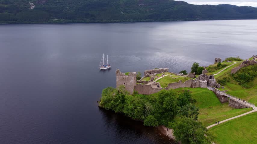 Urquhart Castle and Sailing Boat on Loch Ness – Aerial View of the Scottish Highlands